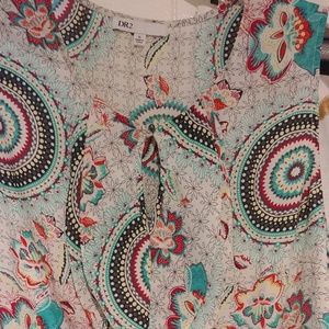 Sleeveless keyhole neck blouse wth ruffle front